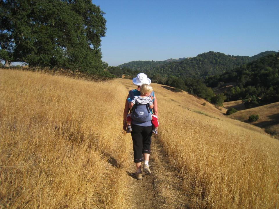 In this July 27, 2008 photo provided by courtesy of Stroller Hikes, baby Maxwell enjoys the views from a backpack carrier along Pena Trail in Calero County Park with his mother on a rugged Stroller Hike in San Jose, Calif. Maxwell grew up with Stroller Hikes, hiking with his mother at least once per week, and now is a healthy and very active first grader that continues to love nature, exercise and outings with his mother. (AP Photo/Courtesy Stroller Hikes, Debbie Frazier)