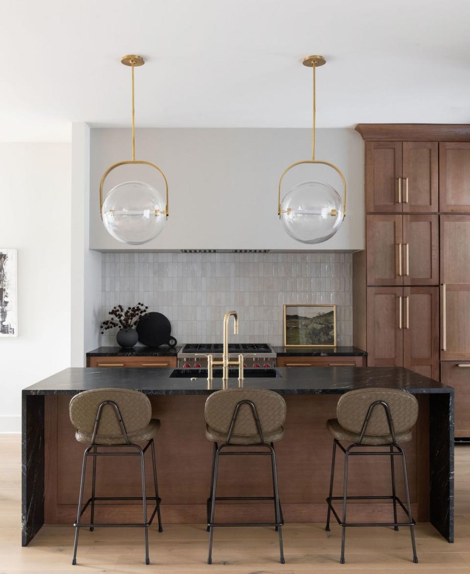 a kitchen with a bar and chairs