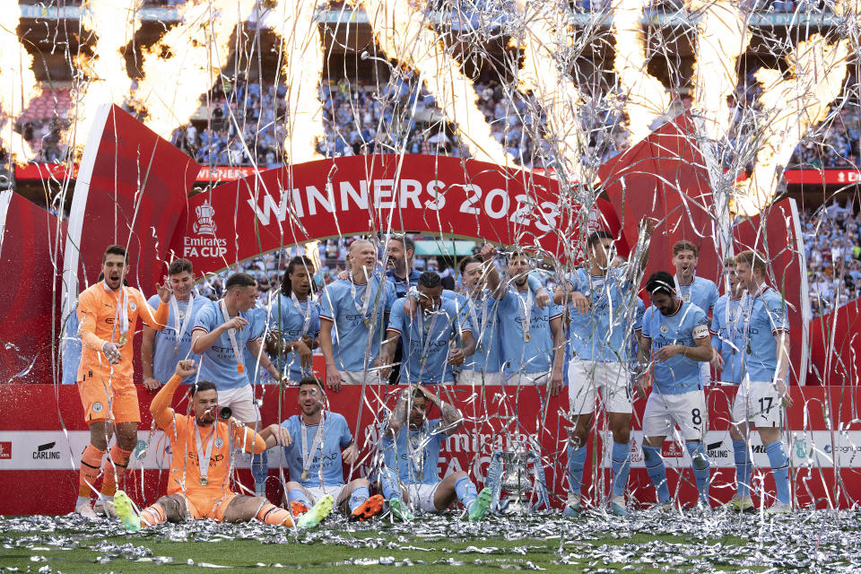 Manchester City players celebrate after winning the English FA Cup final soccer match between Manchester City and Manchester United at Wembley Stadium in London, Saturday, June 3, 2023.(AP Photo/Jon Super)