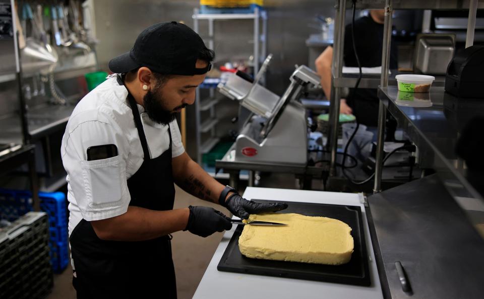 Chef di Cucina John Magsino cuts polenta at Josephine, a new Italian-American restaurant in the Shoppes of Avondale.