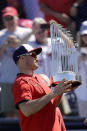 Washington Nationals first baseman Ryan Zimmerman holds the 2019 World Series Trophy before a spring training baseball game against the Houston Astros Sunday, Feb. 23, 2020, in West Palm Beach, Fla. (AP Photo/John Bazemore)