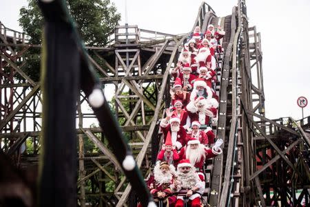 People dressed as Santa Claus ride a roller coaster as they take part in the World Santa Claus Congress, an annual event held every summer at the amusement park Dyrehavsbakken, in Copenhagen, Denmark. Scanpix Denmark/Sarah Christine Noergaard/via REUTERS