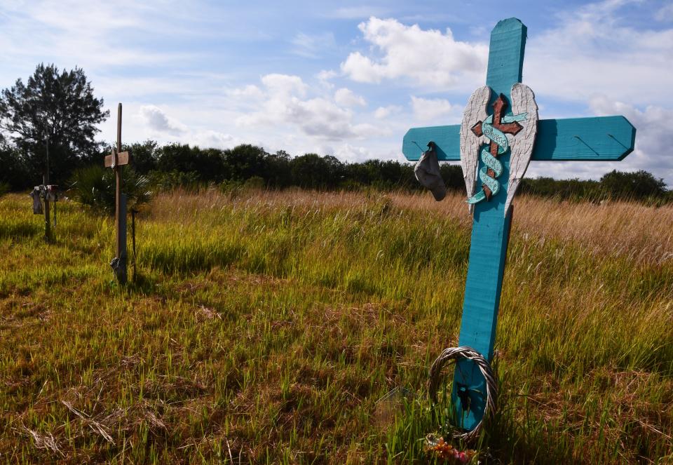 A memorial cross stands in tribute to someone who died in the Compound in southwestern Palm Bay.