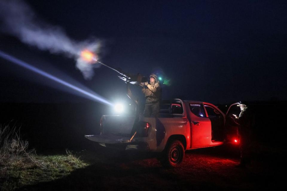 A Ukrainian serviceman from anti-drone mobile air defence unit fires a Browning machine gun at his position during combat (REUTERS)