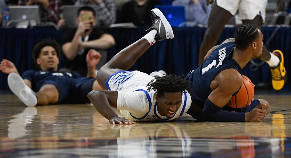 Jan 19, 2022; Chicago, Illinois, USA;  DePaul Blue Demons forward David Jones (32) and Xavier Musketeers guard Paul Scruggs (1) fight for a loose ball during the first half at Wintrust Arena.