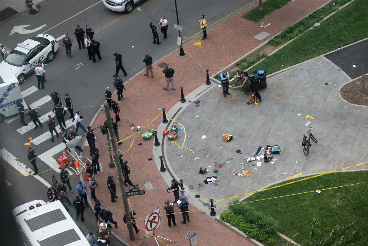 Law enforcement officers investigate at the scene after a gunman opened fire in a park as high school graduates and their families emerged from a theater where commencement exercises had just concluded, in Richmond, Virginia (Reuters)