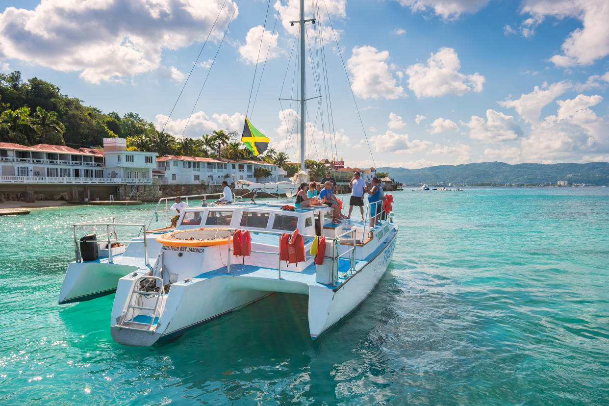 People enjoy a catamaran boat tour at Doctor's Cave Beach in Montego Bay Jamaica on a cloudy day. (Getty Images)