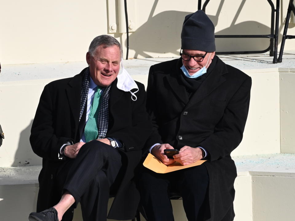 Sen. Mark Warner, D-Va., right, and Sen. Richard Burr, R-N.C, chat before President-elect Joe Biden’s inauguration, Wednesday, Jan. 20, 2021, at the U.S. Capitol in Washington.(Saul Loeb/Pool Photo via AP)