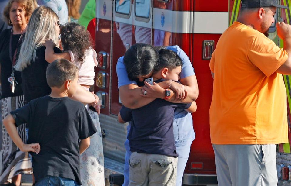 Family members are reunited with their children at the German Township Government Center following a Northwestern School District bus crash on State Route 41 in Springfield, Ohio, Tuesday, Aug. 22, 2023. (Bill Lackey/The Springfield News-Sun via AP)