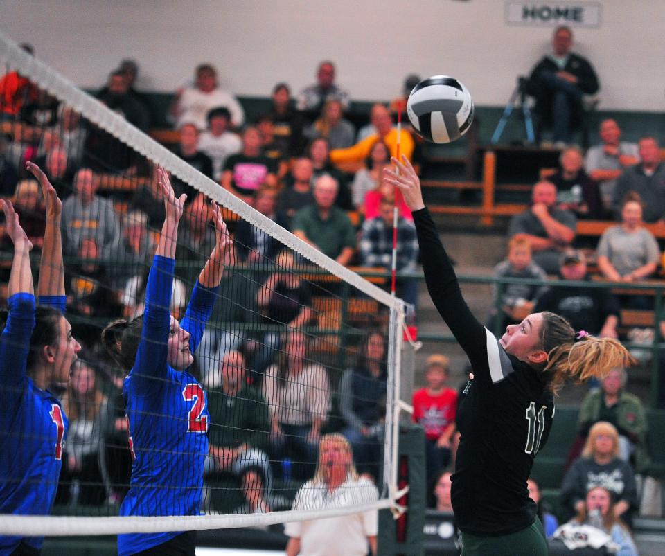 Smithville's Naomi Keib tips the ball over the net against Tuslaw.
