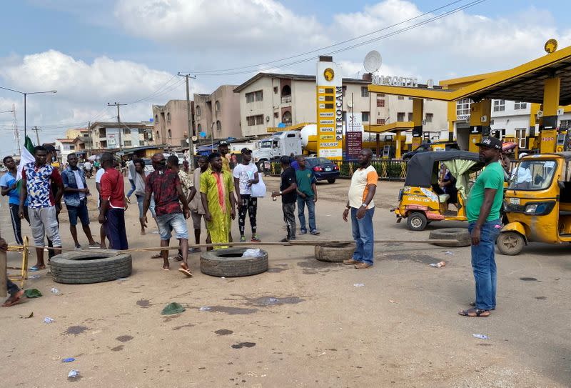 Demonstrators block a road during a protest demanding police reform in Lagos