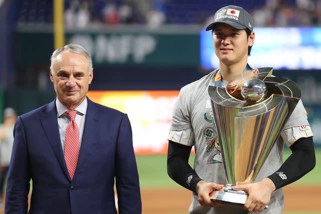 <p>Megan Briggs/Getty</p> Robert D. Manfred Jr. and Shohei Ohtani on March 21, 2023 in Miami, Florida.