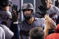Minnesota Twins' Gary Sanchez is congratulated by teammates in the dugout after hitting a solo home run during the fifth inning of a baseball game against the Los Angeles Dodgers Wednesday, Aug. 10, 2022, in Los Angeles. (AP Photo/Mark J. Terrill)
