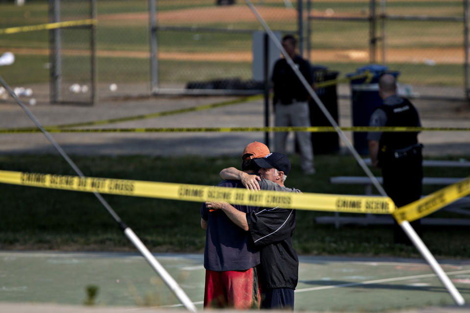 <p>Two people hug in front of police crime scene tape following a shooting during a congressional baseball practice hug near the Eugene Simpson Stadium Park in Alexandria, Va., on Wednesday, June 14, 2017. (Photo: Andrew Harrer/Bloomberg via Getty Images) </p>