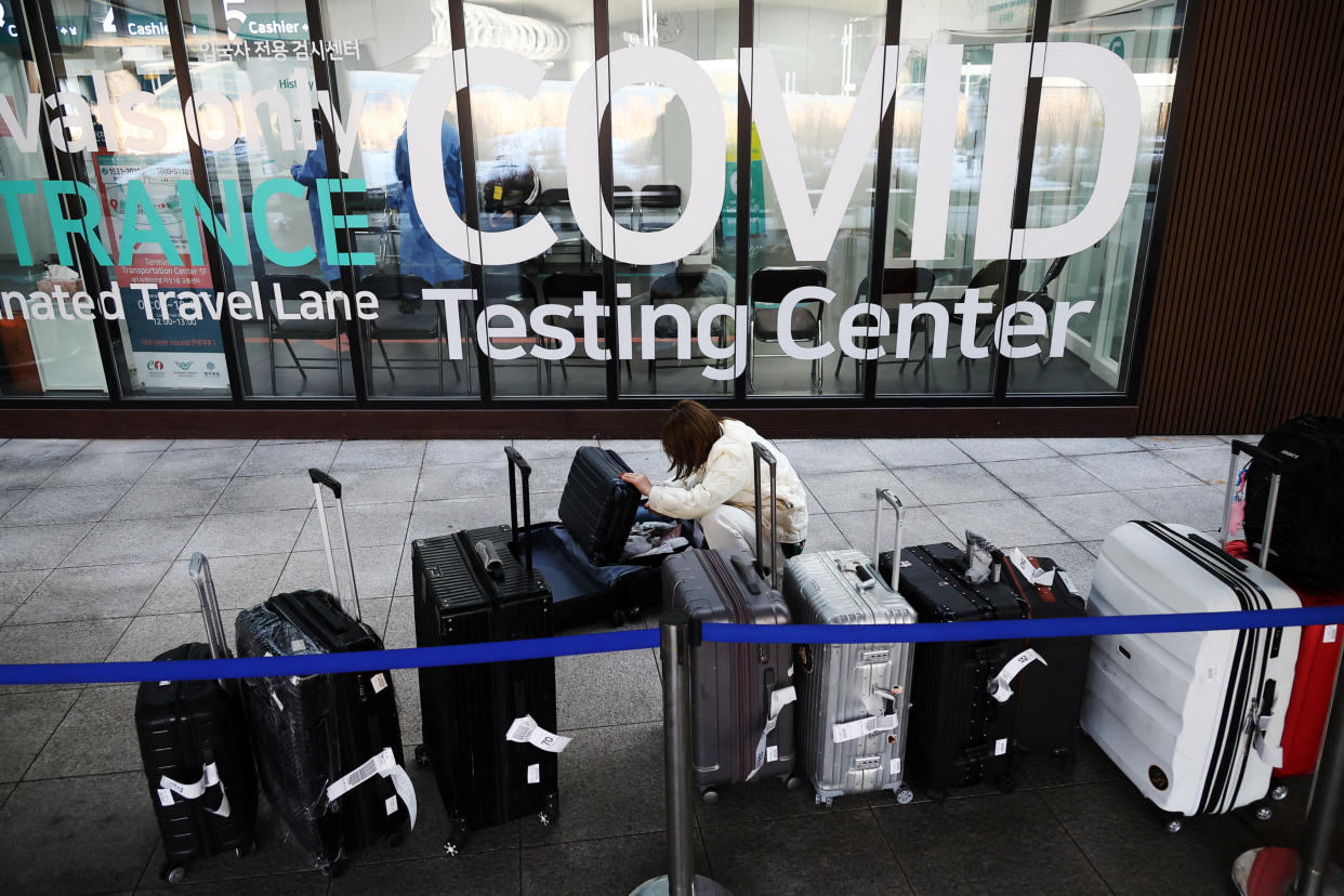 A Chinese tourist checks her luggage as she is waiting for her coronavirus disease (COVID-19) test result upon her arrival at the Incheon International Airport in Incheon, South Korea, January 4, 2023.   REUTERS/Kim Hong-Ji