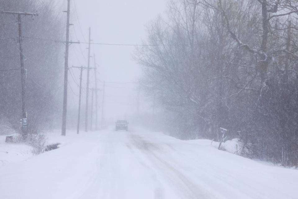 A sudden snowfall drops visibility to a few feet on Ballantyne Road in Chili.  Warm temperatures, rain, then back to cold with several inches of snow are causing minor flooding in low lying areas , February 18, 2022. 