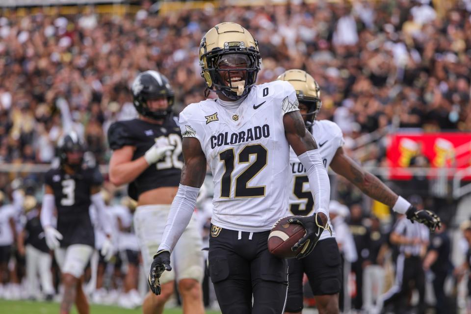 Sep 28, 2024; Orlando, Florida, USA; Colorado Buffaloes wide receiver Travis Hunter (12) scores a touchdown against the UCF Knights during the first quarter at FBC Mortgage Stadium. Mandatory Credit: Mike Watters-Imagn Images