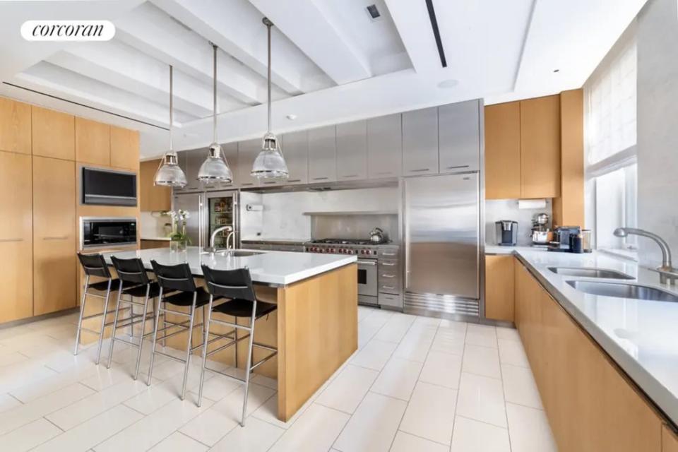 The co-op’s kitchen includes dual refrigerators, a Viking stove and marble floors. City Realty