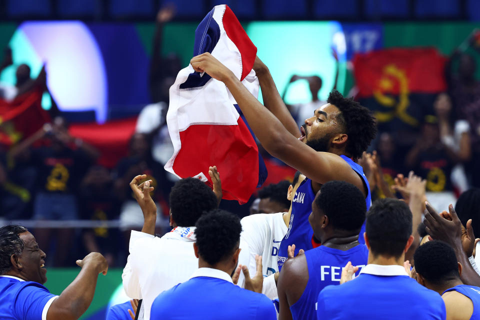Karl-Anthony Towns waves the Dominican Republic flag. (Yong Teck Lim/Getty Images)