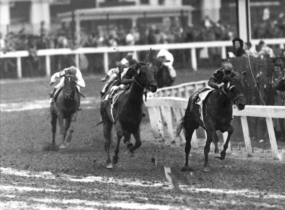 FILE - Citation, center, with Eddie Arcaro in the saddle, comes up on Coaltown, right, during the Kentucky Derby in Louisville, Ky., May 1, 1948. Citation chased Coaltown throughout the 1 1/4-mile race before pulling away to a 3 1/2-length victory. (AP Photo)