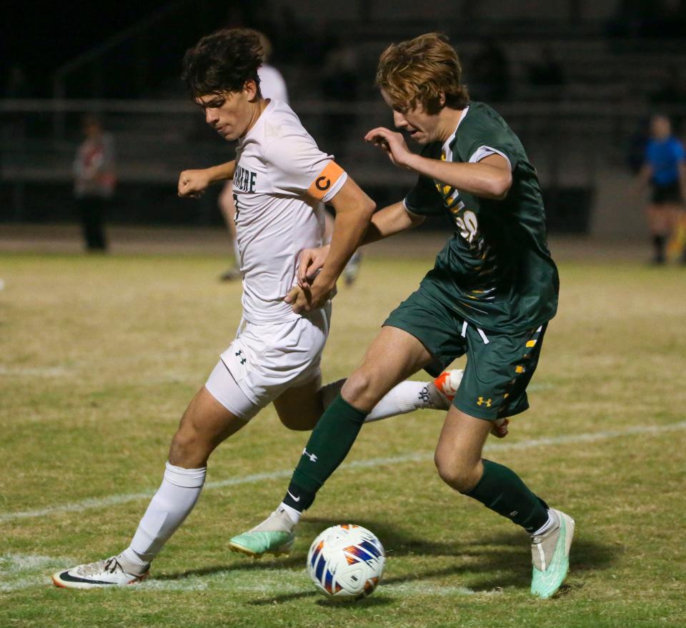 Archmere's Jason Lotkowski (left) and Saint Mark's Zach Burns push for the ball in the second half of the Spartans' 4-0 win in the opening round of the DIAA Division II state tournament at Saint Mark's, Tuesday, Nov. 7, 2023.