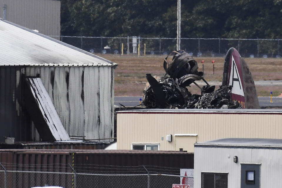 Wreckage is seen where World War II-era bomber plane crashed at Bradley International Airport in Windsor Locks, Conn., Wednesday, Oct. 2, 2019. A fire with black smoke rose from near the airport as emergency crews responded. The airport said in a message on Twitter that it has closed. (AP Photo/Jessica Hill)