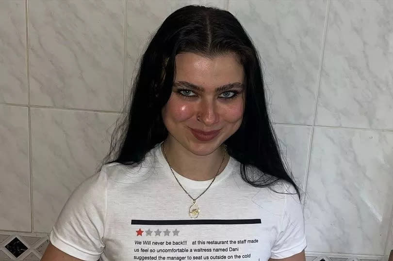 A woman with a t shirt with a one-star review printed onto it