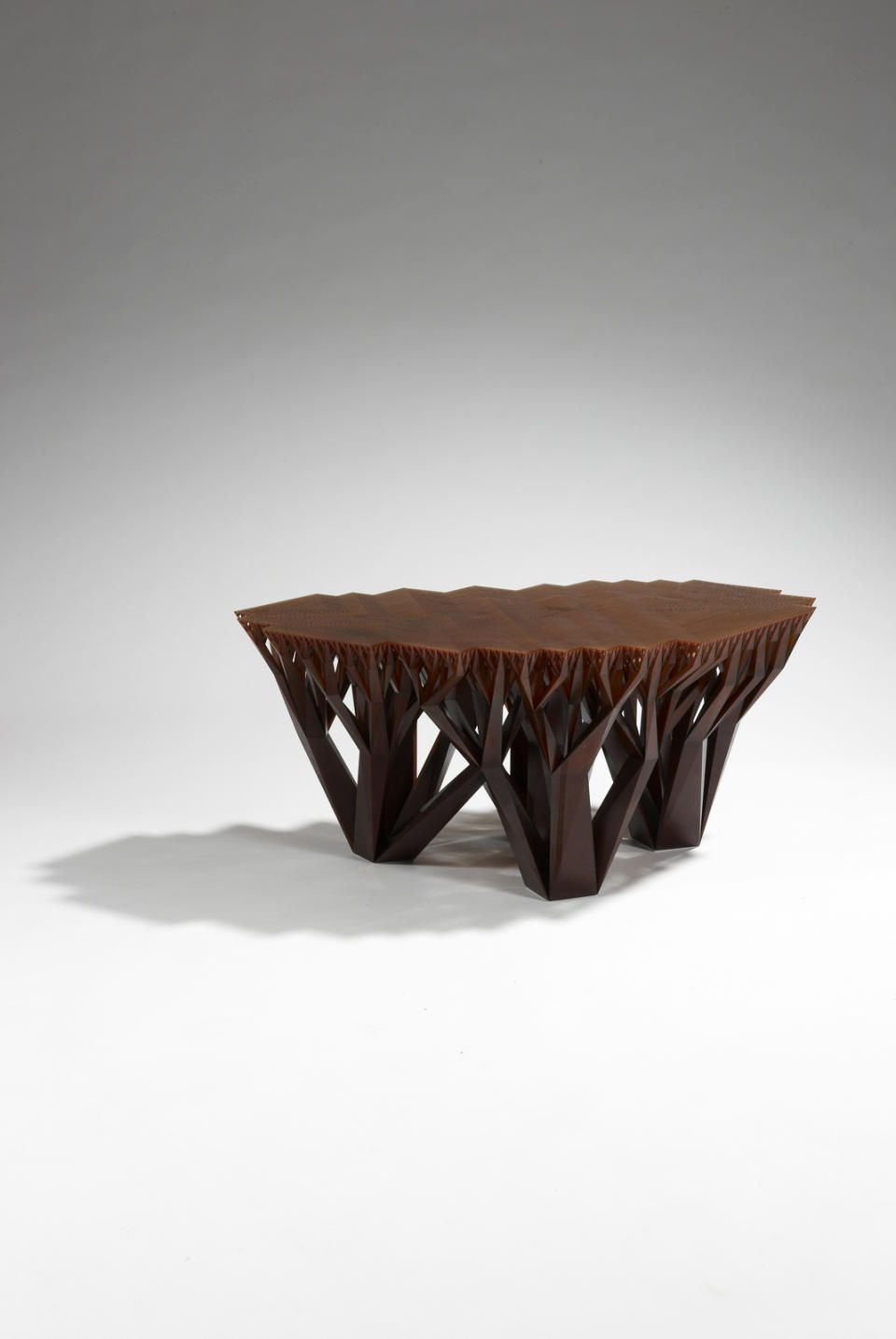 This photo provided by .MGX by Materialise shows a Fractal.MGX coffee table by WertelOberfell, made from a brown epoxy resin from the design division of Belgium-based 3-D printing company, Materialise. It was designed after the growth patterns of trees, whose stems grow into smaller branches until becoming very dense toward the top. A novelty once reserved for science-fiction, 3-D printing has gone mainstream in home decor thanks to cheaper, more accessible technology. (AP Photo/.MGX by Materialise, Copyright StéphaneBriolantParis)