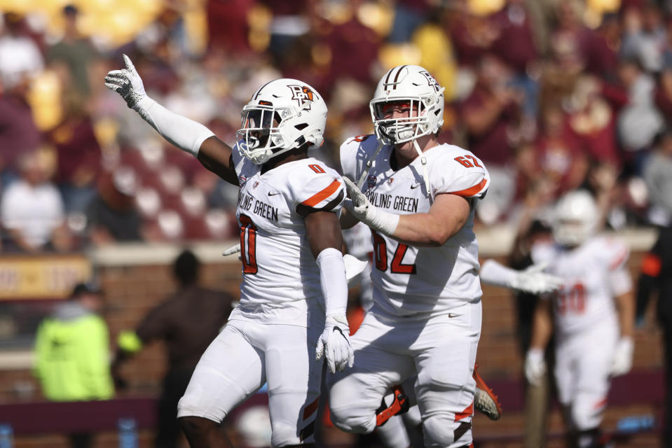 Bowling Green safety Jordan Anderson (0) celebrates with teammate guard Malone VanGorder (62) after winning 14-10 during an NCAA college football game Saturday, Sept. 25, 2021, in Minneapolis. (AP Photo/Stacy Bengs)