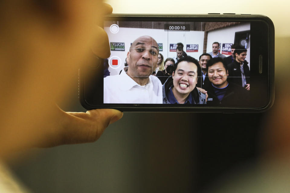 New Jersey Democratic Sen. Cory Booker takes a video selfie with attendees after speaking at a get out the vote event hosted by the NH Young Democrats at the University of New Hampshire in Durham, N.H. Sunday, Oct. 28, 2018. (AP Photo/ Cheryl Senter)