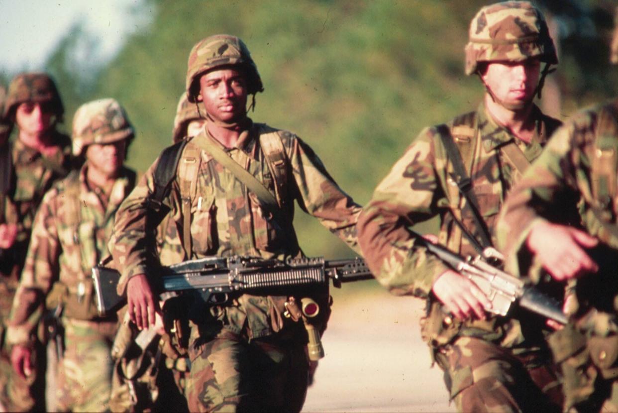 Paratroopers with the 82nd Airborne Division patrol the island nation of Grenada in October 1983.