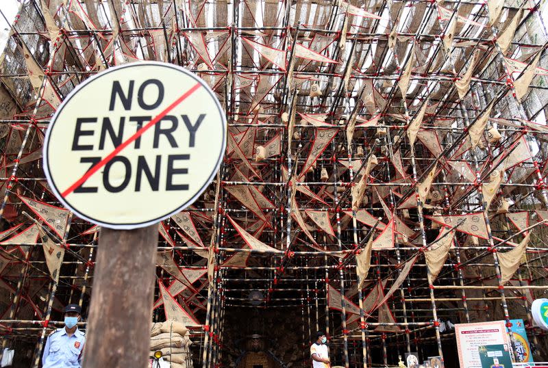 Notice hangs outside a closed "pandal" on first day of Durga Puja festival in Kolkata