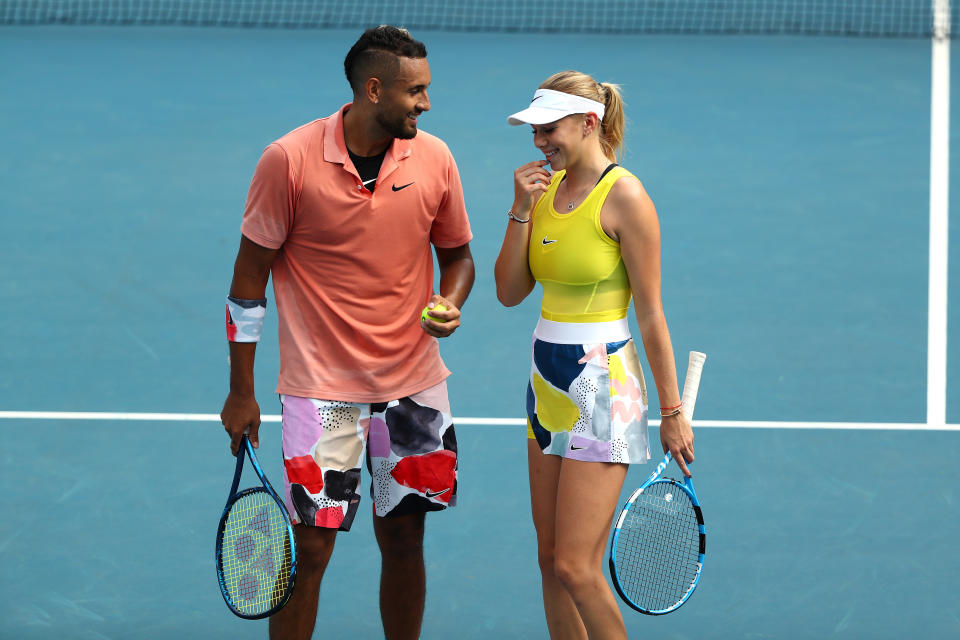 Nick Kyrgios and Amanda Anisimova laugh during their Mixed Doubles first round match.