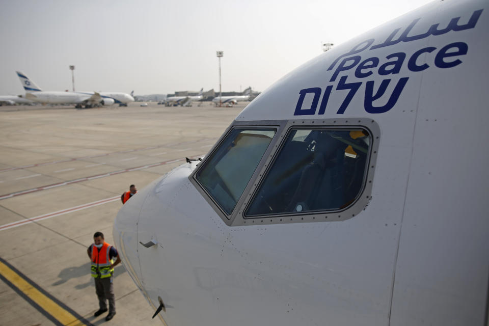 The Arabic, English and Hebrew word for "peace" is seen on the Israeli flag carrier El Al's airliner which will carry Israeli and U.S. delegations to Abu Dhabi for talks meant to put final touches on the normalization deal between the United Arab Emirates and Israel, at Ben Gurion Airport, near Tel Aviv, Israel Monday, Aug. 31, 2020.(Nir Elias/Pool Photo via AP)