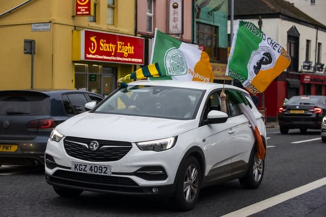 Celtic supporters in Belfast celebrate their club being awarded the 2019-20 title after the season was ended early 