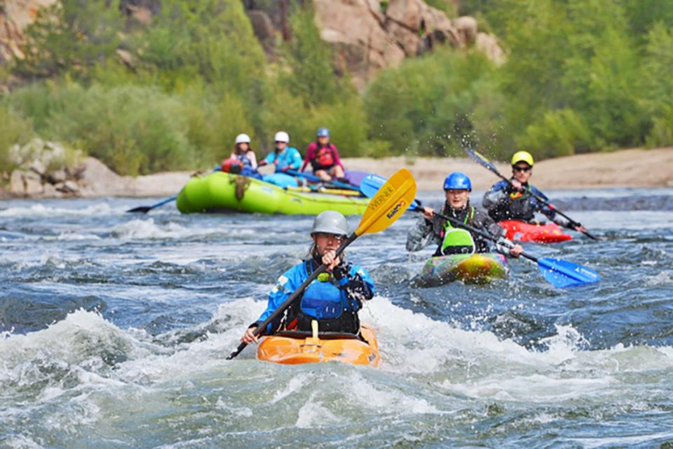 Kayakers and rafters take to the water on the Arkansas River where it was a banner summer for outfitters providing kayak lessons and guided raft trips.