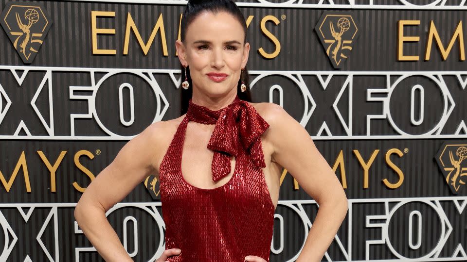 Juliette Lewis’s red Moschino dress resembled Emily Blunt’s gown from the previous evening’s Critics Choice Awards, though it featured a bow and halter neck rather than a rosette and single-sleeve shoulder line. - Kevin Mazur/Getty Images