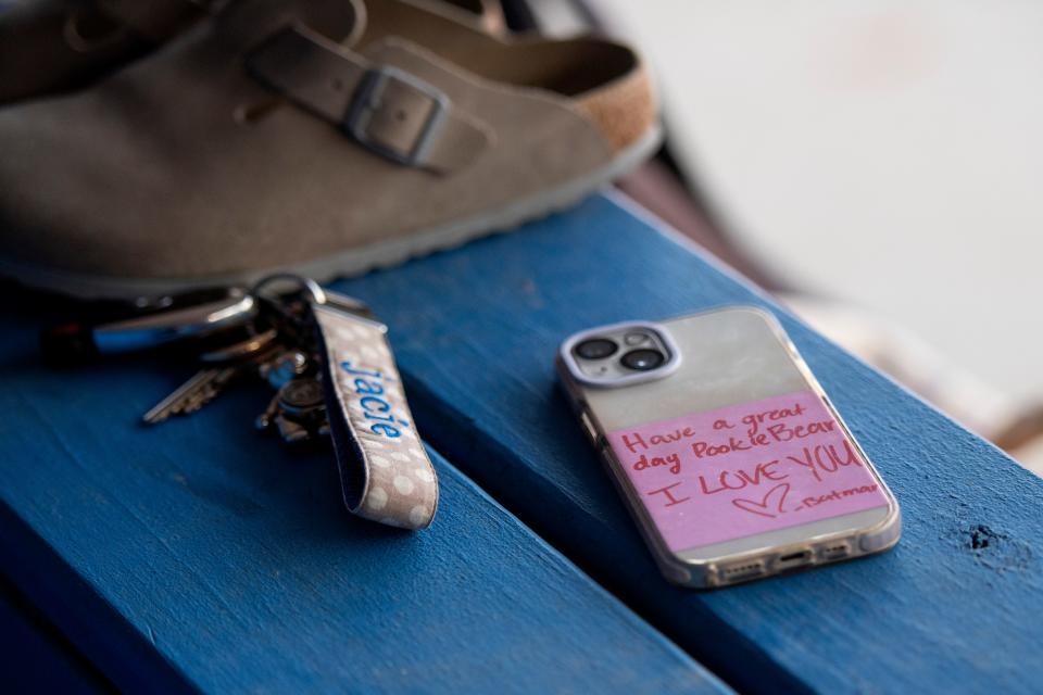 Shoes, keys and a phone belonging to Evansville Christian’s Jacie Arnold is seen in the dugout Wednesday, April 26, 2023. The note is from her younger sister Elcie Arnold.