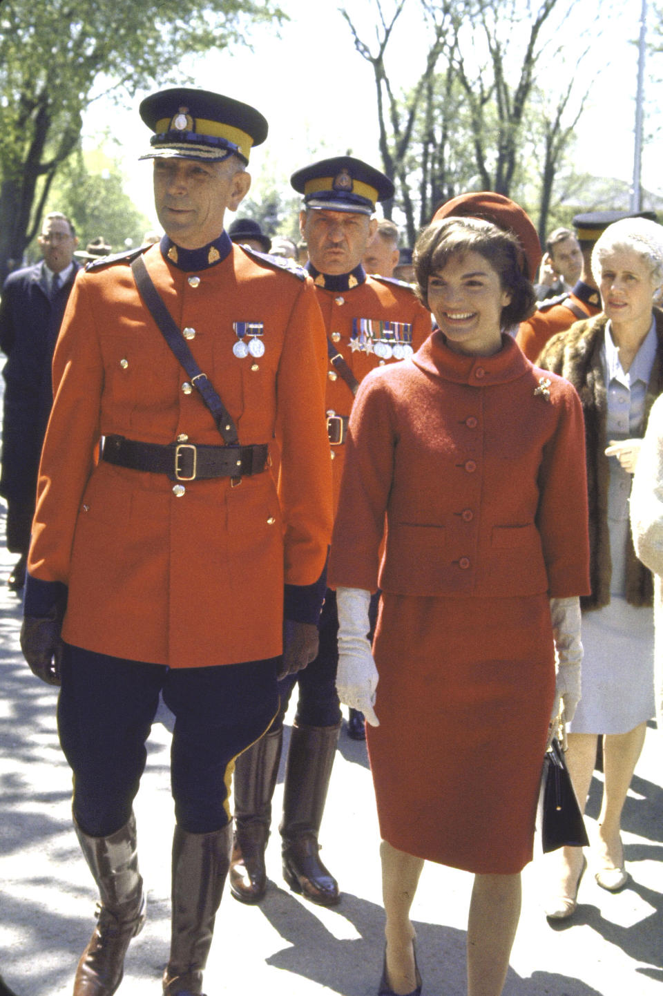 Kennedy walks with Royal Canadian Mounted Police Commissioner Clifford Harvison during a state visit to Canada.