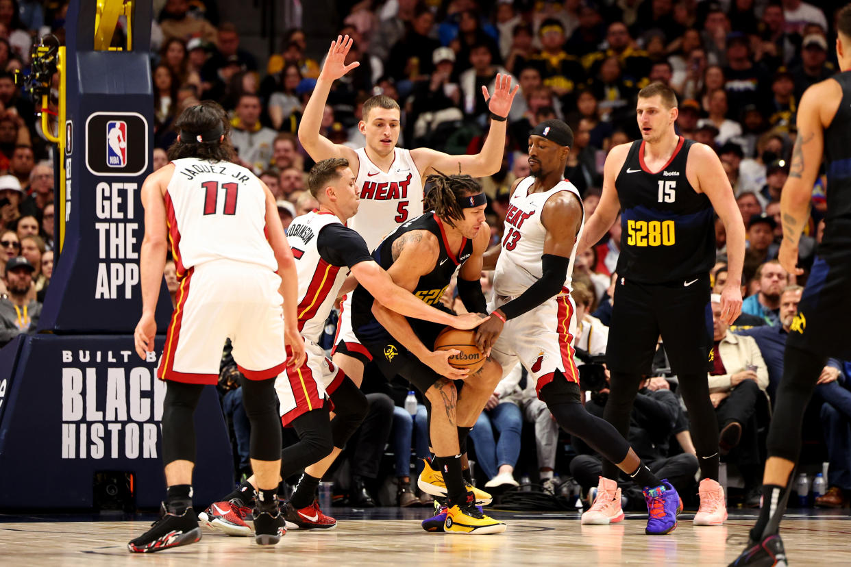 DENVER, COLORADO - FEBRUARY 29: Duncan Robinson #55, Nikola Jovic #5 and Bam Adebayo #13 of the Miami Heat double-team Aaron Gordon #50 of the Denver Nuggets at Ball Arena on February 29, 2024 in Denver, Colorado. NOTE TO USER: User expressly acknowledges and agrees that, by downloading and/or using this Photograph, user is consenting to the terms and conditions of the Getty Images License Agreement. (Photo by Jamie Schwaberow/Getty Images)