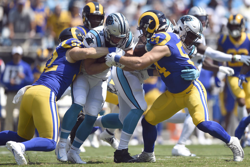 Los Angeles Rams outside linebacker Clay Matthews (52) and linebacker Bryce Hager (54) tackle Carolina Panthers running back Christian McCaffrey (22) during the first half an NFL football game in Charlotte, N.C., Sunday, Sept. 8, 2019. (AP Photo/Mike McCarn)