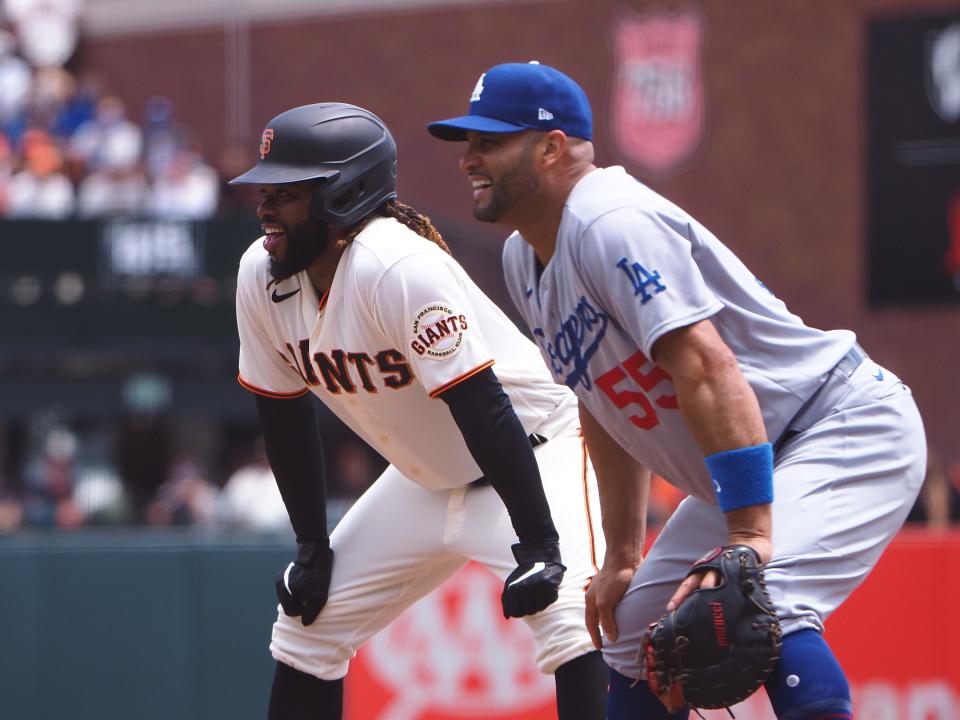 Giants pitcher Johnny Cueto and Dodgers first baseman Albert Pujols during a game in July.