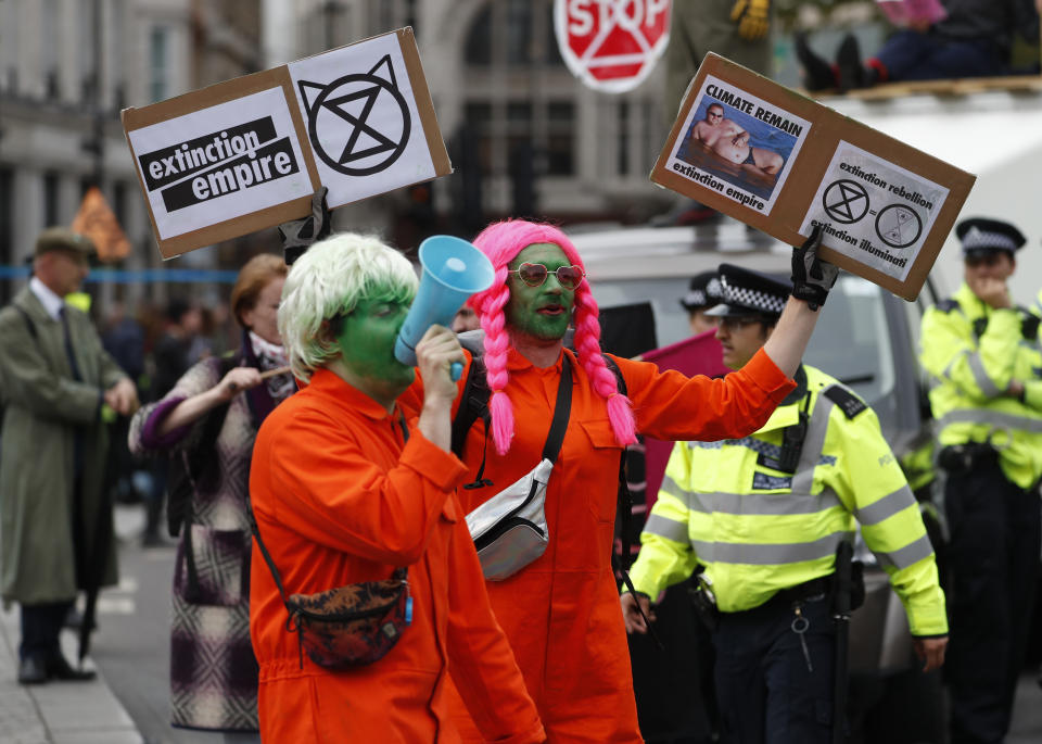 Climate protestors block a road in central London Monday, Oct. 7, 2019. Extinction Rebellion movement blocked major roads in London, Berlin and Amsterdam on Monday at the beginning of what was billed as a wide-ranging series of protests demanding new climate policies. (AP Photo/Alastair Grant)