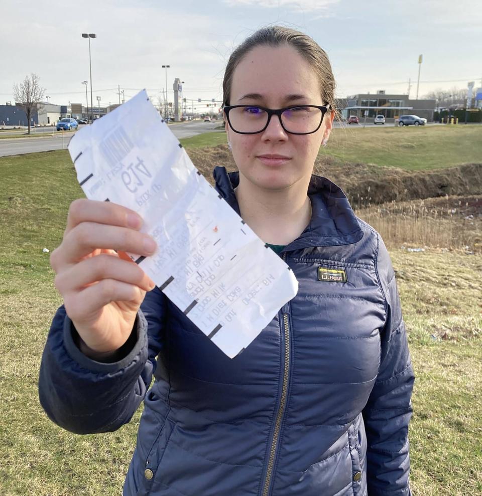 Elizabeth Kiddo, a 29-year-old Bemus Point, New York, resident, shows a receipt, one of the blood-stained items she received during a visit to McDonald's, 7200 Peach St., on March 9.