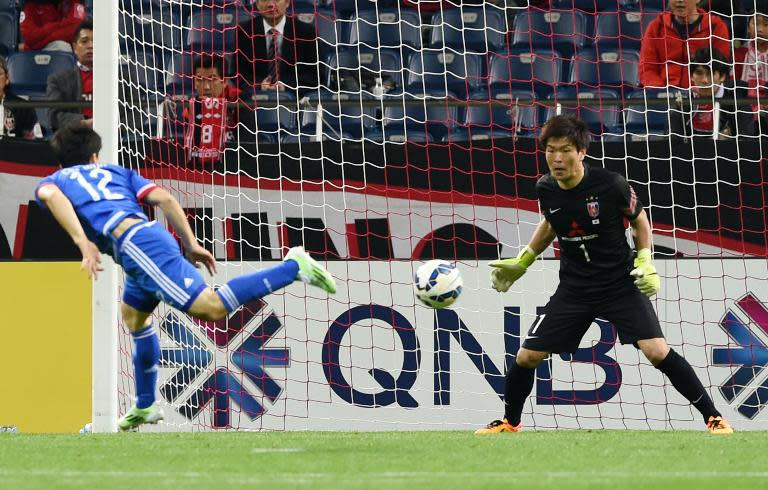 South Korea's Suwon Bluewings midfielder Ko Cha-Won (L) scores against Japan's Urawa Reds in their AFC champions league group match on April 21, 2015