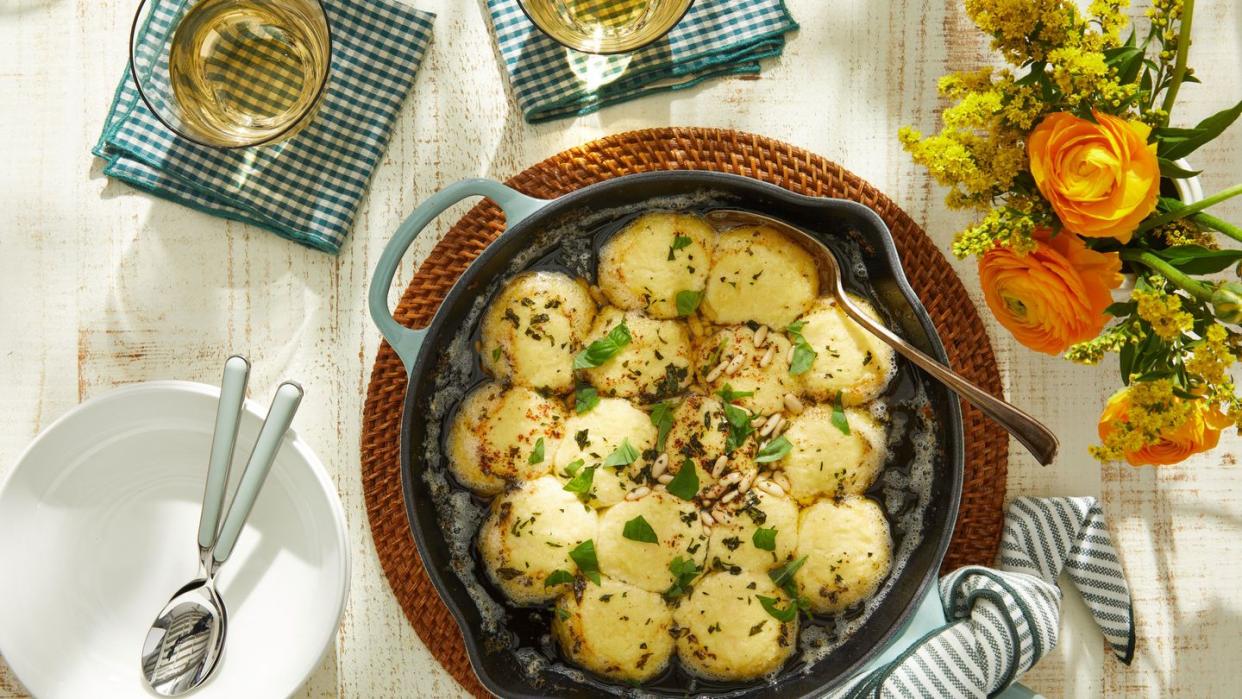 a bowl of gnudi with brown butter sauce