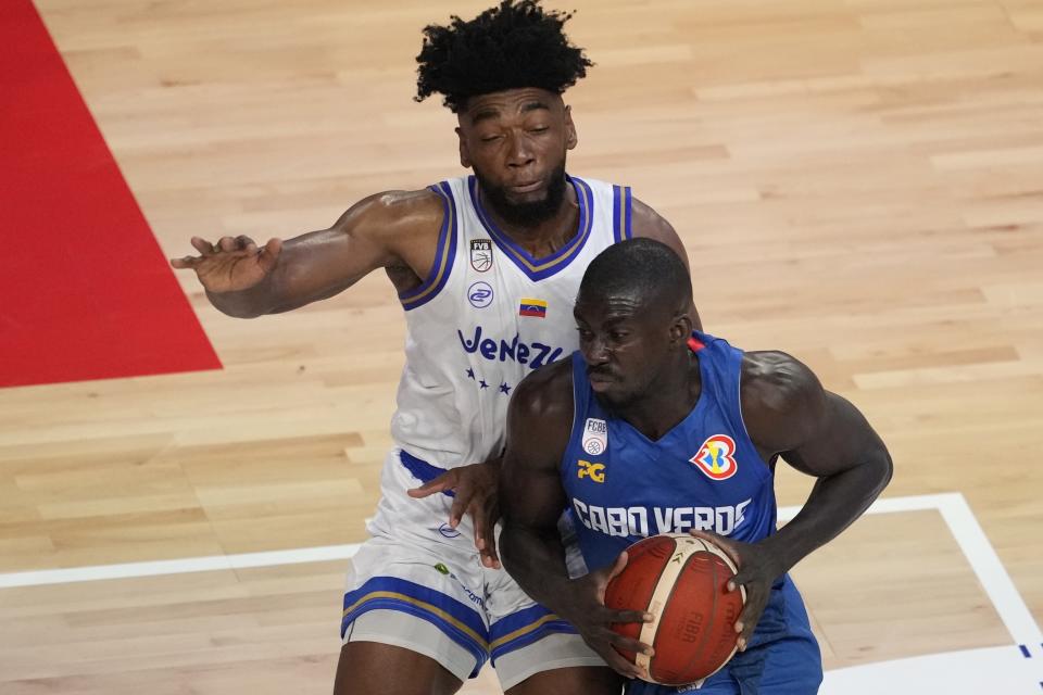 Cape Verde guard Anderson Correia (8) drives against Venezuela guard Pedro Chourio (9) in the first half of the Basketball World Cup group F match in Okinawa, southern Japan, Monday, Aug. 28, 2023. (AP Photo/Hiro Komae)