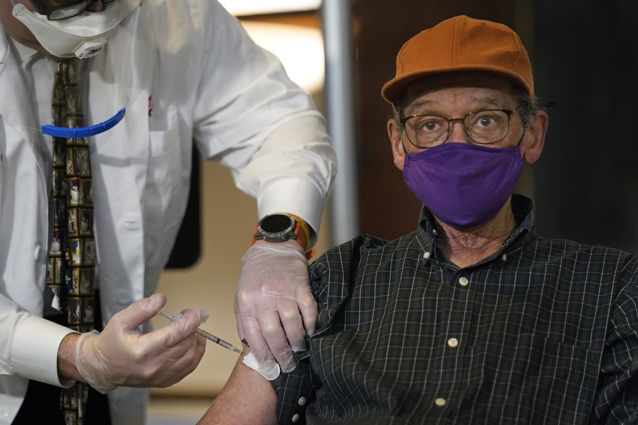 In this Dec. 21, 2020 file photo, Kelley Dixon, 78, is vaccinated against COVID-19 at his residence in The Hebrew Home in Riverdale. An ambitious goal of vaccinating 1 million New York City residents against COVID-19 in January was set Thursday by Mayor Bill de Blasio, who noted that meeting the target would require outside cooperation and the city dramatically increasing access.