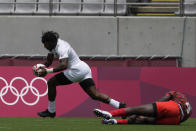 Carlin Isles of the U.S. gets past Kenya's Vincent Onyala, right, to score a try in their men's rugby sevens match at the 2020 Summer Olympics, Monday, July 26, 2021 in Tokyo, Japan. (AP Photo/Shuji Kajiyama)