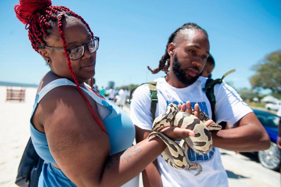 Spring breakers show off snakes during Black Spring Break in Biloxi on Saturday, April 13, 2024.